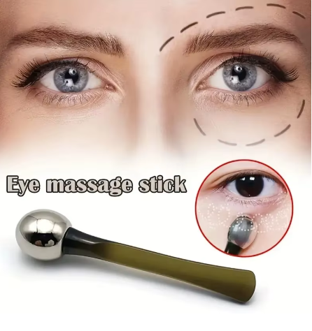 Gold-tone eye roller held in hand