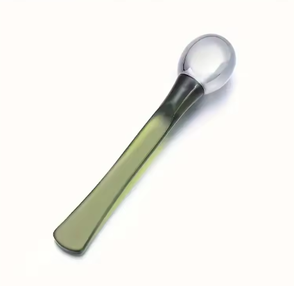 Gold alloy eye roller and applicator spoon detail